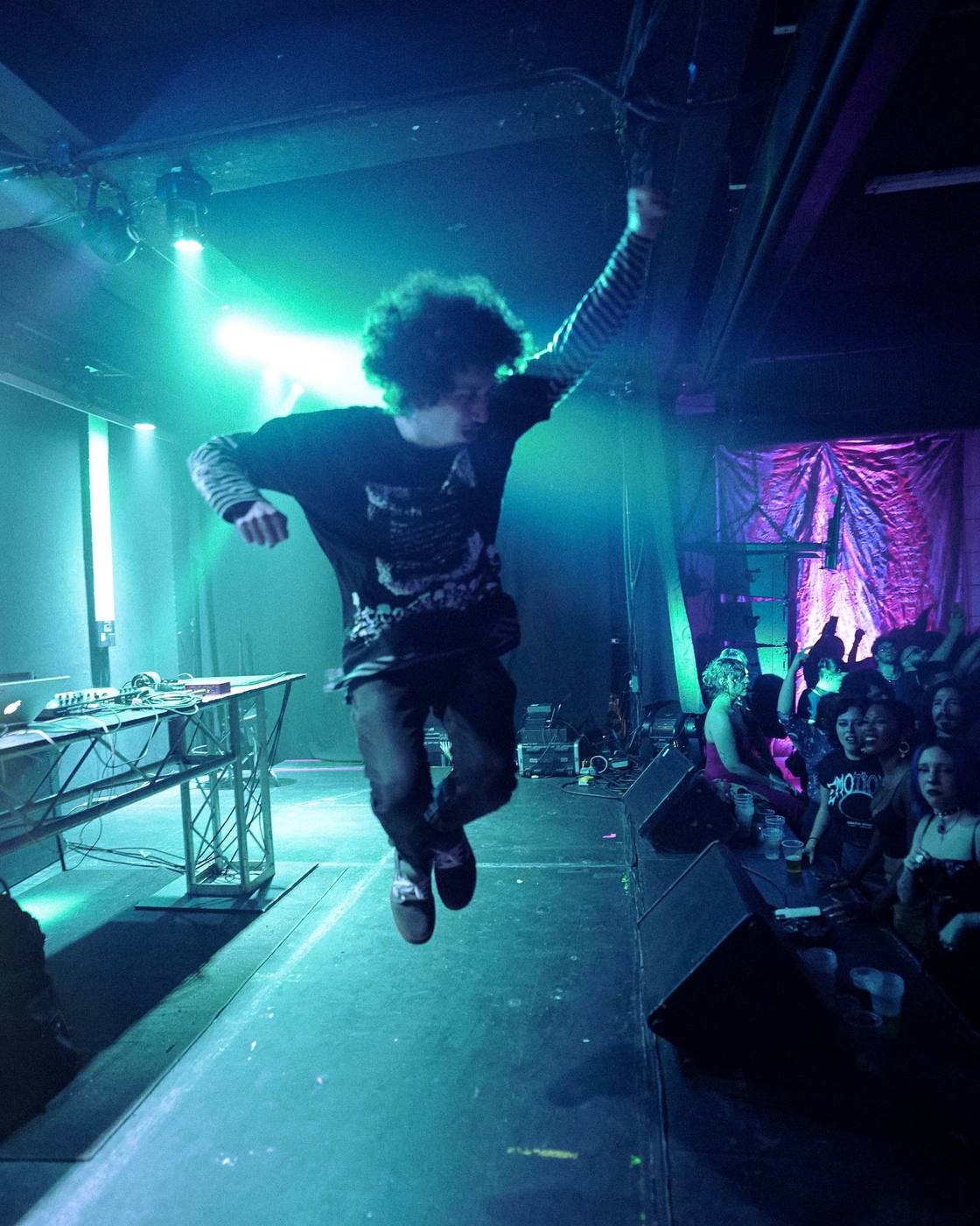 Bencore jumping above the stage during a live performance